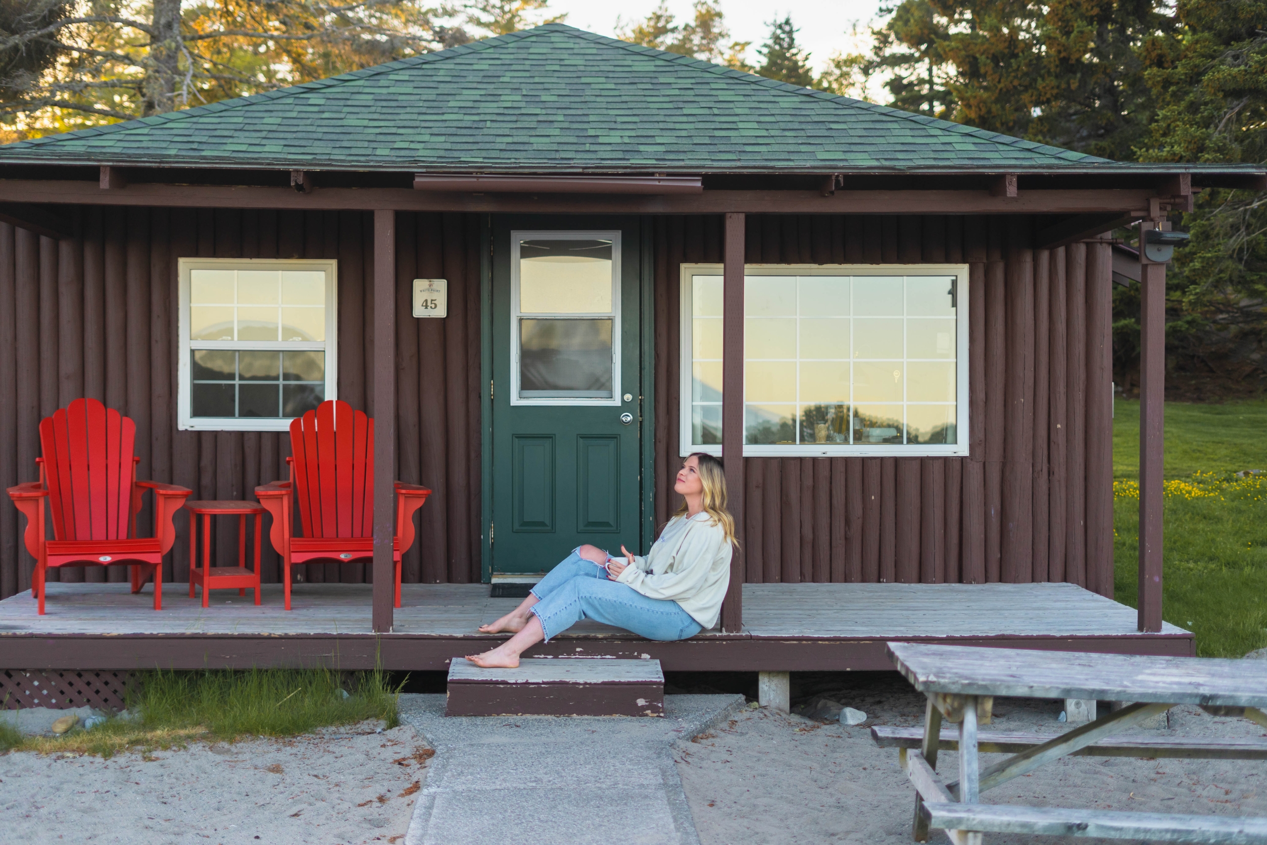 Woman sitting outside her cottage
