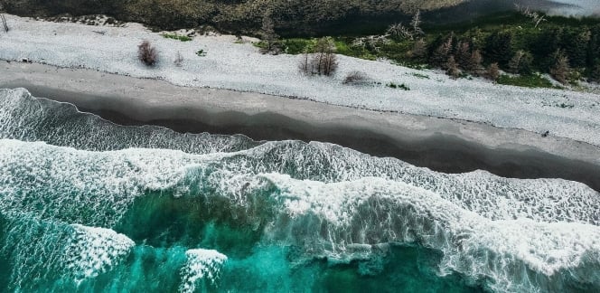 aerial view of ocean waves on a beach