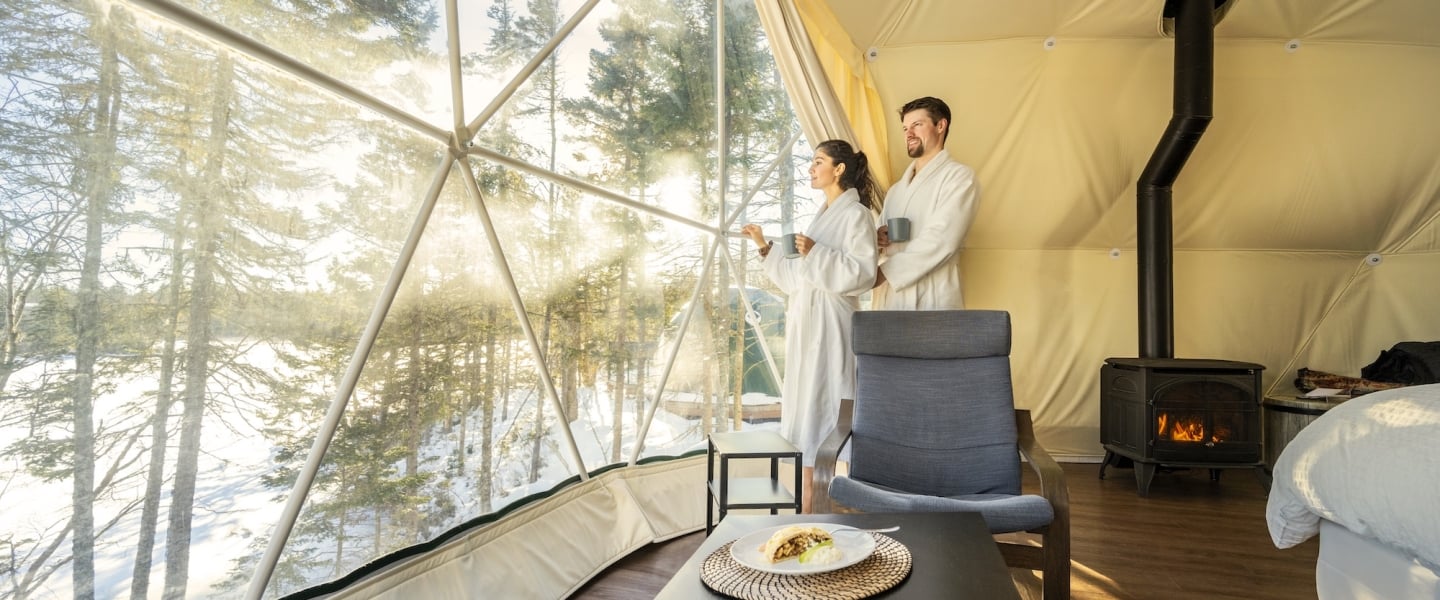 a couple drinking coffee in robes in a glome at White Point Beach Resort