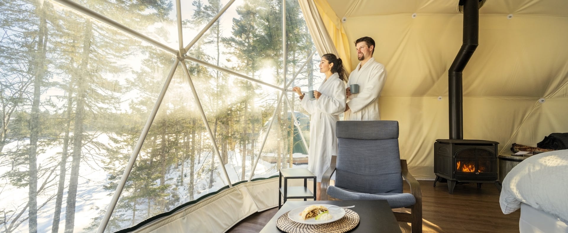 a couple drinking coffee in robes in a glome at White Point Beach Resort
