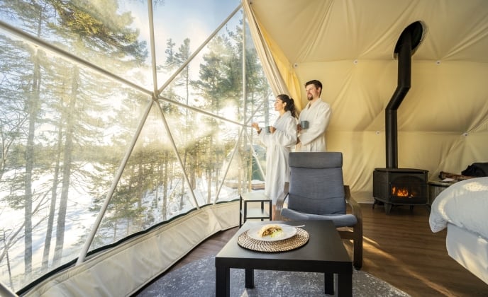 a couple drinking coffee in robes in a glome at White Point Beach Resort
