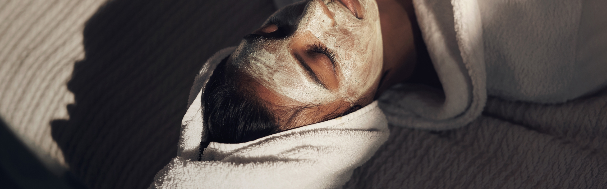 Woman enjoying spa facial treatment