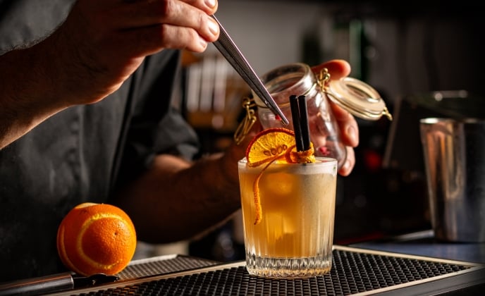 Preparing Smoky Spiced Orange Cocktail