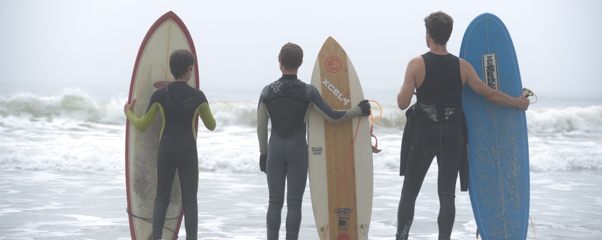 a family surfing at White Point Beach Resort