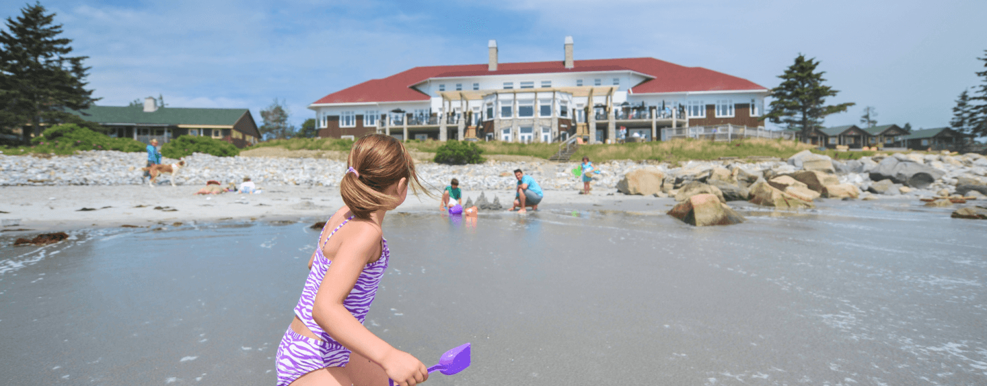families playing on the beach at White Point Beach Resort