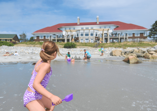 families playing on the beach at White Point Beach Resort