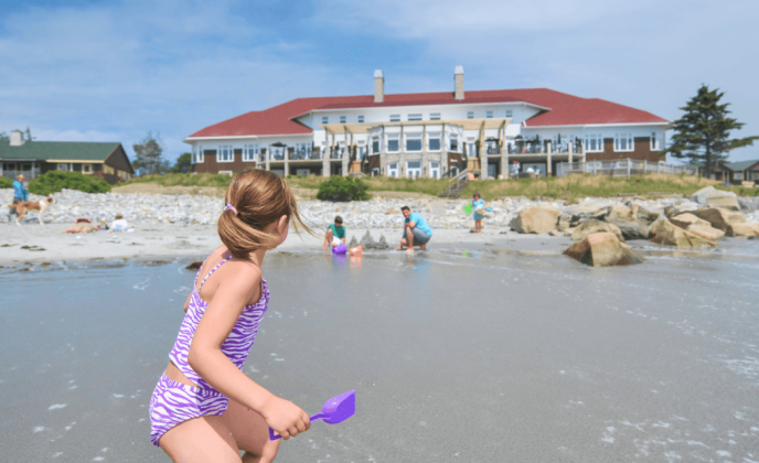 families playing on the beach at White Point Beach Resort