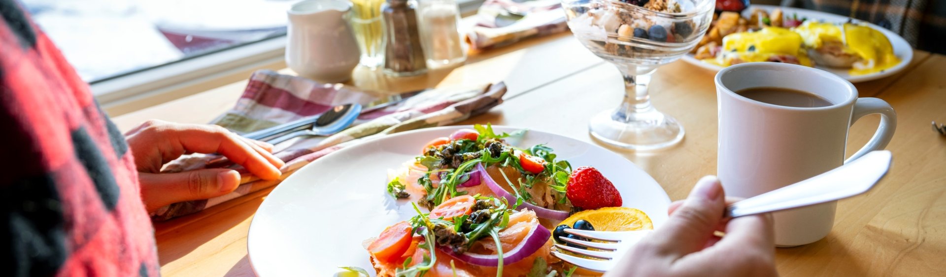 a couple eating breakfast with an ocean view