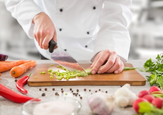 The chef slicing vegetables.